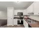 Charming kitchen featuring modern appliances, white cabinets, and sleek, dark countertops at 2920 Barrymore St # 106, Raleigh, NC 27603