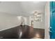 Inviting living room with dark hardwood floors, a staircase, and an opening leading to the kitchen at 2920 Barrymore St # 106, Raleigh, NC 27603