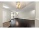 Bright living room with dark floors and neutral walls adjacent to the entry door at 2920 Barrymore St # 106, Raleigh, NC 27603
