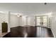 Spacious living room with dark hardwood floors, neutral walls, and natural light at 2920 Barrymore St # 106, Raleigh, NC 27603
