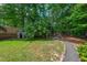 Lush backyard with a charming playhouse and a fire pit, creating a perfect outdoor retreat at 3 White Ash Dr, Durham, NC 27712