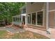 Stunning backyard showcases a screened porch and a stone patio, perfect for outdoor entertaining and relaxation at 3 White Ash Dr, Durham, NC 27712