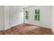Bedroom features wood floors, white walls, double door closet and windows with natural views at 3 White Ash Dr, Durham, NC 27712