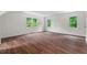 Spacious bedroom with wood floors, natural light from windows overlooking the yard at 3 White Ash Dr, Durham, NC 27712