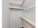 Closet with white shelving and wood rods, offering plenty of storage space at 3 White Ash Dr, Durham, NC 27712