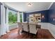 Elegant dining room with large windows, stylish chairs, and hardwood floors at 3 White Ash Dr, Durham, NC 27712