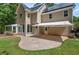 Backyard featuring a stone patio and screened porch, accentuated by an awning and lush greenery at 3 White Ash Dr, Durham, NC 27712