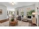 Bright living room with hardwood floors, fireplace, and lots of natural light from the surrounding windows at 3 White Ash Dr, Durham, NC 27712