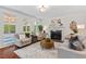 Cozy living room with large windows, hardwood floors, and a fireplace feature at 3 White Ash Dr, Durham, NC 27712