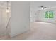 Loft area with carpet, window with natural light, and view of the stairway at 3 White Ash Dr, Durham, NC 27712