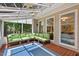 Relaxing sunroom featuring a ceiling fan, many windows, and comfortable seating with views of the backyard at 3 White Ash Dr, Durham, NC 27712