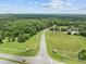 A landscape shot showcasing a road leading through fields and trees at 31 W Madison, Pittsboro, NC 27312