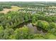 Picturesque aerial view of a wooded community surrounding a tranquil pond at 31 W Madison, Pittsboro, NC 27312