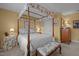 A bright bedroom features a canopy bed, neutral carpet, and a window, creating a peaceful retreat at 31 W Madison, Pittsboro, NC 27312