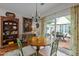 Bright dining area with a round table, green chairs, and sliding doors to the patio at 31 W Madison, Pittsboro, NC 27312