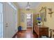 Bright foyer features hardwood floors, a decorative mirror, and a striking stained-glass door at 31 W Madison, Pittsboro, NC 27312