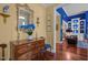 Foyer area featuring hardwood floors, a wooden dresser, and views into the blue living room at 31 W Madison, Pittsboro, NC 27312