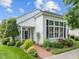Welcoming home entrance with a red brick pathway, lush landscaping, and classic black shutters at 31 W Madison, Pittsboro, NC 27312