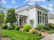 Charming home exterior with manicured lawn, brick pathway, and lush landscaping, offering great curb appeal at 31 W Madison, Pittsboro, NC 27312