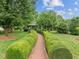 Picturesque gazebo nestled in a serene garden setting, surrounded by manicured hedges and greenery at 31 W Madison, Pittsboro, NC 27312