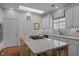 Well-lit kitchen with white cabinets, granite countertops, and a functional center island at 31 W Madison, Pittsboro, NC 27312