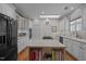 Bright kitchen with white cabinetry, an island with seating, and a skylight at 31 W Madison, Pittsboro, NC 27312