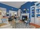 Spacious living room with a fireplace, custom built-ins, and an open view of the dining area at 31 W Madison, Pittsboro, NC 27312