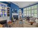 Stylish living room with custom built-ins, a cozy fireplace, and large windows with natural light at 31 W Madison, Pittsboro, NC 27312