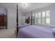 Bright main bedroom features a four-poster bed, large windows and ample closet space at 31 W Madison, Pittsboro, NC 27312