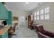 A home office is enhanced with custom shelving, a large window and plush seating at 31 W Madison, Pittsboro, NC 27312