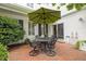 This patio features a brick-paved surface, outdoor seating, and an umbrella for shade, perfect for enjoying the outdoors at 31 W Madison, Pittsboro, NC 27312