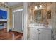 Elegant powder room with floral wallpaper, a decorative mirror, and a white vanity at 31 W Madison, Pittsboro, NC 27312