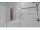 Walk-in shower features marble tile, a glass door, and chrome fixtures at 31 W Madison, Pittsboro, NC 27312