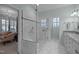 Large glass walk-in shower with a bench seat and a view to the main bedroom at 31 W Madison, Pittsboro, NC 27312