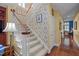 Traditional stairway with floral wallpaper and carpeted steps at 31 W Madison, Pittsboro, NC 27312