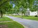 Quiet street featuring well-kept houses and mature trees providing ample shade and curb appeal at 31 W Madison, Pittsboro, NC 27312