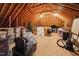 Spacious unfinished attic providing ample storage space with exposed rafters and plywood flooring at 325 Wescott Ridge Dr, Holly Springs, NC 27540