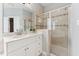 Bathroom featuring a glass-enclosed shower and a vanity with a sink, providing a modern, clean design at 325 Wescott Ridge Dr, Holly Springs, NC 27540