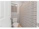 Cozy bathroom featuring a toilet, shower with striped curtain, and a window letting in natural light at 325 Wescott Ridge Dr, Holly Springs, NC 27540