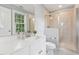 Bright bathroom with a modern vanity, shower, and a window offering a view of the outdoors at 325 Wescott Ridge Dr, Holly Springs, NC 27540