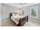 Serene bedroom featuring a sleigh bed with a plush blanket and two windows, bathed in natural light at 325 Wescott Ridge Dr, Holly Springs, NC 27540