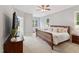Comfortable bedroom with a ceiling fan, natural light, and neutral decor at 325 Wescott Ridge Dr, Holly Springs, NC 27540