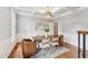Stylish dining room with coffered ceiling, hardwood floors, a modern chandelier, and elegant decor at 325 Wescott Ridge Dr, Holly Springs, NC 27540