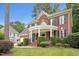 Charming brick home featuring a rounded front porch with decorative pillars and well-maintained landscaping on a green lawn at 325 Wescott Ridge Dr, Holly Springs, NC 27540