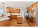 Spacious kitchen boasting stainless steel appliances, wood cabinetry, and a functional island at 325 Wescott Ridge Dr, Holly Springs, NC 27540