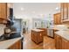 Bright kitchen featuring stainless steel appliances, wood cabinets, island, and hardwood floors at 325 Wescott Ridge Dr, Holly Springs, NC 27540