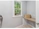 Bright laundry area with a window looking out onto the yard; includes shelving and storage at 325 Wescott Ridge Dr, Holly Springs, NC 27540