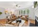 Open-concept living room with hardwood floors, ample windows, and comfortable seating at 325 Wescott Ridge Dr, Holly Springs, NC 27540
