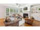 Cozy living room featuring a fireplace, built-in shelving, and comfortable leather seating at 325 Wescott Ridge Dr, Holly Springs, NC 27540