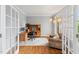 Bright home office with French doors, hardwood floors, a wooden desk setup, and a comfortable seating area at 325 Wescott Ridge Dr, Holly Springs, NC 27540